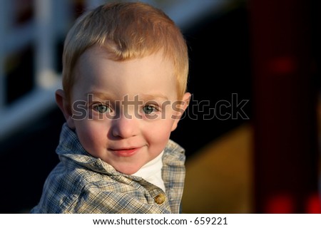 portrait of a young, redheaded boy in the late afternoon sun