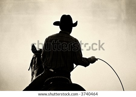 cowboy at the rodeo - shot backlit against big cloud of dust, converted with added grain