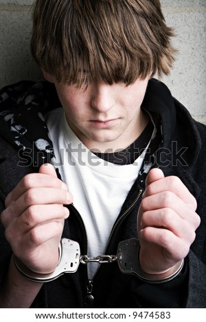 teen male portrait wearing handcuffs