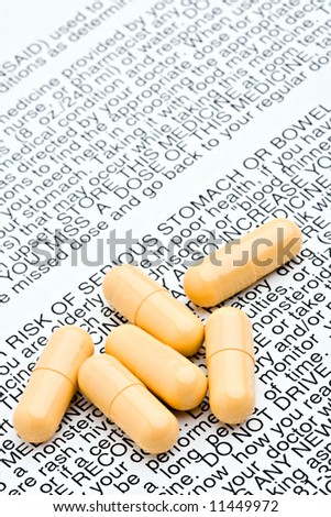 pills closeup - generic pills and warning label / directions indicating health risks and side-effects