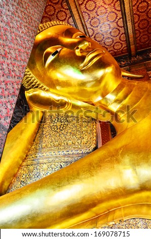 BANGKOK - 13 August 2013 : The Golden Reclining Buddha in Wat Pho temple (Wat Phra Chetuphon Vimolmangklararm Rajwaramahaviharn) Wat Pho is named after a monastery in India where the Lord Buddha lived