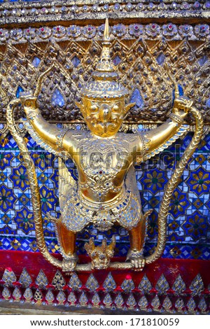 BANGKOK - 9 January 2014 : The Golden Shiny Garuda (Krut) support the base  of Wat Phra Kaew, Temple of Emerald Buddha in Grand Palace, the iconic landmark in Bangkok, Thailand