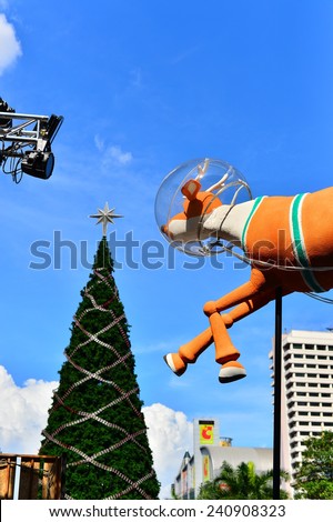 BANGKOK- 28 December 2014 : The huge Christmas tree in front of Central World Plaza, Bangkok One of the shopping area in Thailand. The tree is as tall as the building. This year is a Snoopy Theme