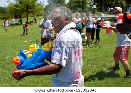ATLANTA, GA - JULY 28:  Unidentified people take part in a water gun battle called the Fight4Atlanta, a squirt gun fight between dozens of locals at Freedom Park on July 28, 2012 in Atlanta.