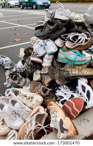 LAWRENCEVILLE, GA - NOVEMBER 23:  Tennis shoes sit piled high in a parking lot as part of Gwinnett County\'s America Recycles Day event, on November 23, 2013 in Lawrenceville, GA.