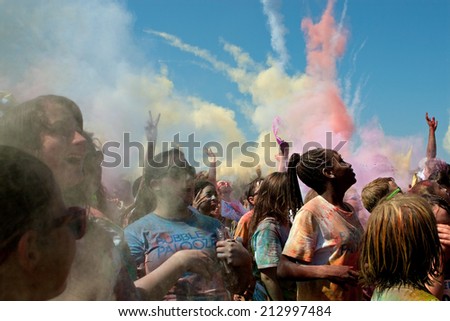 LAWRENCEVILLE, GA - MAY 31:  People throw packets of colored corn starch in the air to create a color explosion at Bubble Palooza, on May 31, 2014 in Lawrenceville, GA.