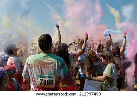 LAWRENCEVILLE, GA - MAY 31:  People throw packets of colored corn starch in the air to get covered in color at Bubble Palooza, on May 31, 2014 in Lawrenceville, GA.