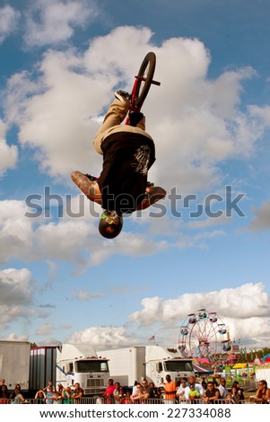 HAMPTON, GA - SEPTEMBER 27:  A young man with the High Roller BMX club flips upside down while performing a BMX stunt at the Georgia State Fair on September 27, 2014 in Hampton, GA.
