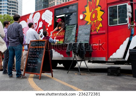 ATLANTA, GA - OCTOBER 16:  Customers wait in line to order meals from a popular food truck during their lunch hour, at \