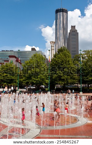ATLANTA, GA - SEPTEMBER 6: Kids get wet playing in the fountain at Centennial Park on a hot summer day on September 6, 2014 in Atlanta, GA.