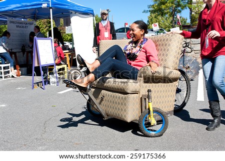 DECATUR, GA - OCTOBER 4:  A woman steers and pedals a unique reclining chair equipped with wheels at the annual Maker Faire Atlanta on October 4, 2014 in Decatur, GA.