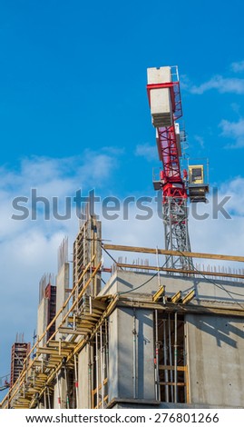 Concrete formwork, reinforcing bars and crane on the office building construction site