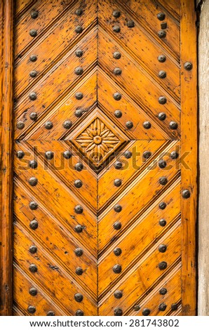 Old wooden door decorated with flower carved in wood