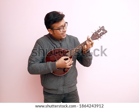 Similar – Image, Stock Photo Man playing mandolin