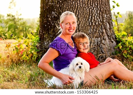 Happy Mom with her Child and a Pet Dog