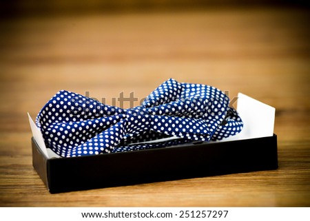 Blue bow tie with white dots placed in the holder