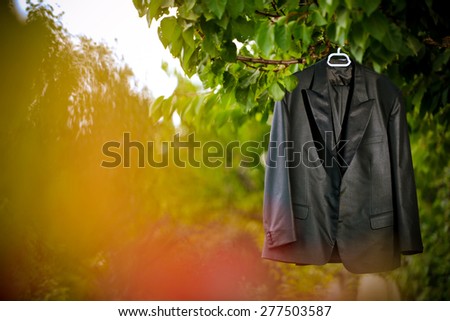 Groom suit hanging by the tree