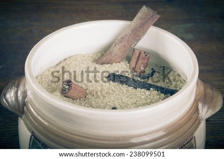 Brown sugar and spices on dark wooden background in ceramic ware. tinted