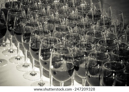 Stemware of red wine on a white table. Banquet. Toned.