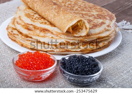 Russian pancakes - blini with red and black caviar.