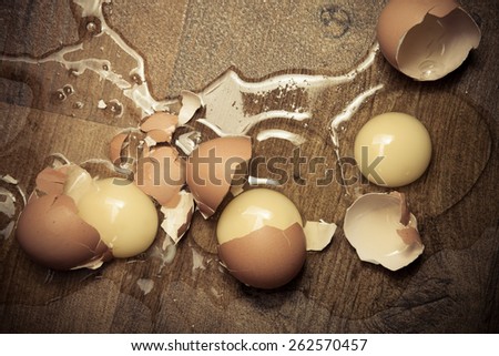 Broken eggs on the wooden floor. Toned.