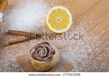 Homemade pastries on a light wooden table with flour.