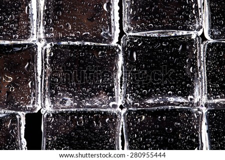 Wall of wet Ice cubes on black background. Selective focus.