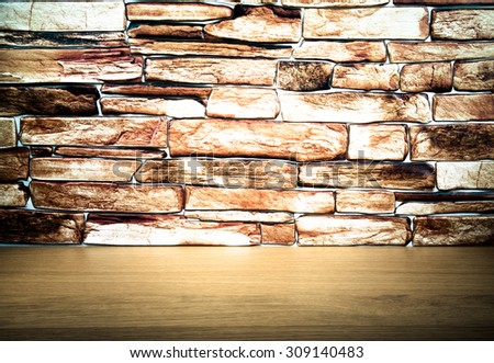 wooden table and stone wall. Background. The edges are darker.