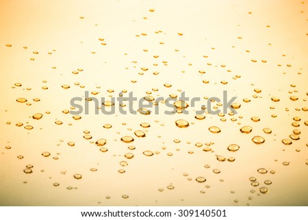 Water droplets on a gold mirror surface. selective focus.