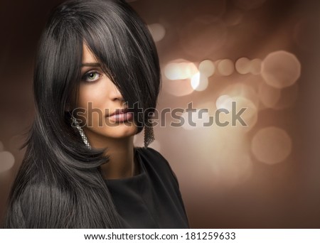 portrait of a young beautiful girl with shiny hair on the background bokeh
