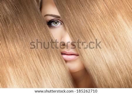 girl look through shining shiny blonde hair