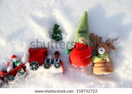 Christmas decoration small funny boy with elk in the snowdrift