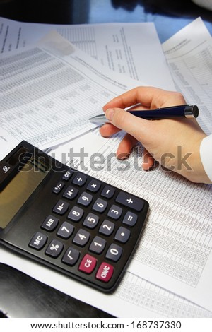 Calculator, pen and accounting document with a lot of numbers and woman