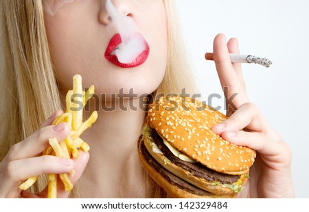 woman eating junk food and smoking