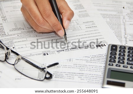 Person filling 1040 federal tax form