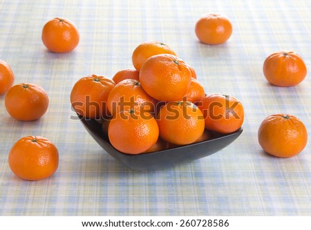 Orange fruits in a bowl on a picnic table