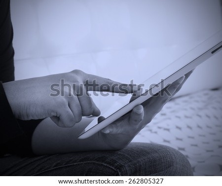 Person browsing internet on a tablet computer with wireless cellular technology