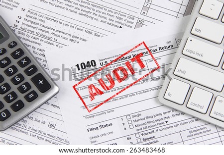 Online tax filing - federal 1040 form with computer keyboard and calculator