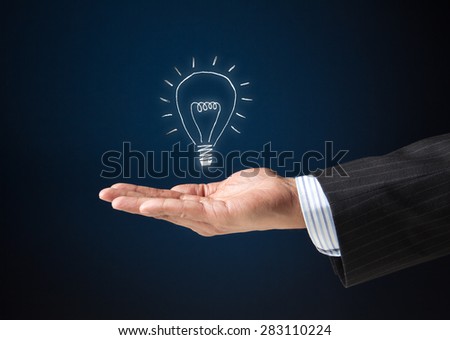 Extended arm of a businessman with a floating bulb icon. Concept image for idea, creativity, genius