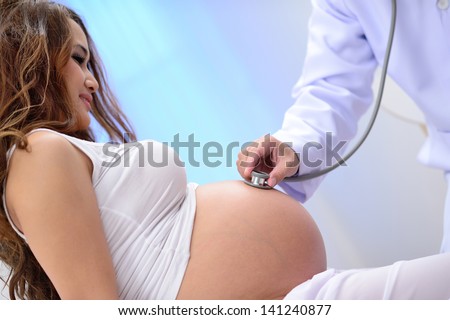 doctor listen big stomach pregnant woman