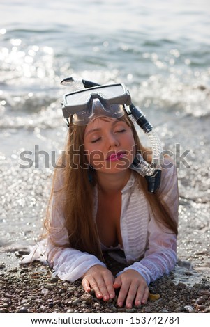 Woman snorkeler with goggles, and snorkel smiling in summer bikini