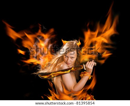 Beautiful red hair girl with a sword in a flame on black background