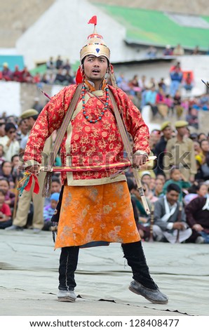 LEH, LADAKH, INDIA - SEPT 08, 2012: Artist in tibetan costumes performing folk dance and singing in a praise of great king of Ladakh. Annual Festival of Ladakh Heritage in Leh, India. Sept 08, 2012.