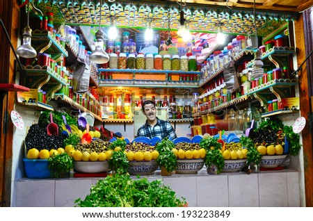 FEZ, MOROCCO - MARCH 5, 2014: Men selling colored olives in a street  market in Fez medina, Morocco
