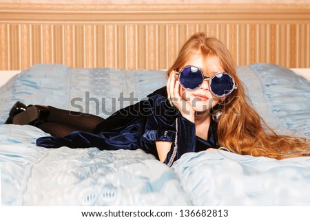 Portrait of cute girl lying in the bed