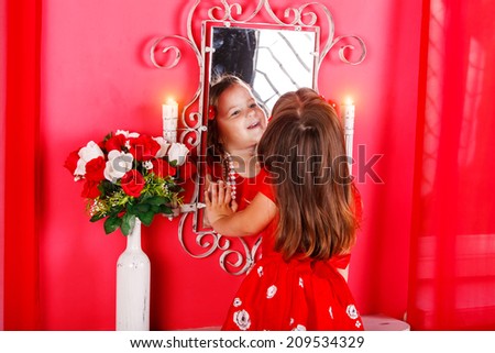 fashion little doll girl in red vanity mirror with lipstick