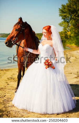 Portrait of beautiful bride with horse