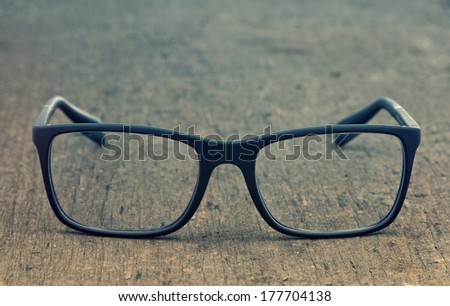 Geek eyeglasses laying on a grungy wooden background