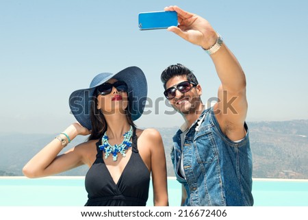 Portrait of couple taking photos with a smartphone, Couples taking Selfie