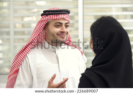 Arabian Business man having a discussion with an arabian businesswoman in the office